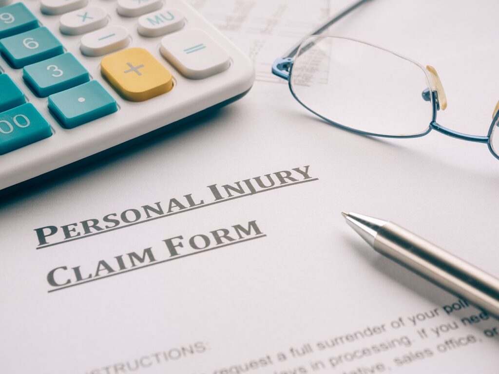 personal injury claim form on desk.